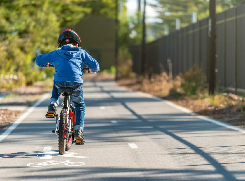 Kid riding his bicycle on bike lane