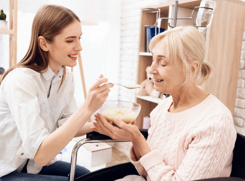 3336243 Girl is nursing elderly woman at home. Girl is helping w