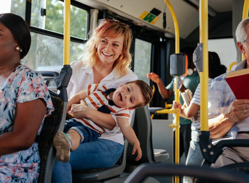 Mom and her son playing during bus ride