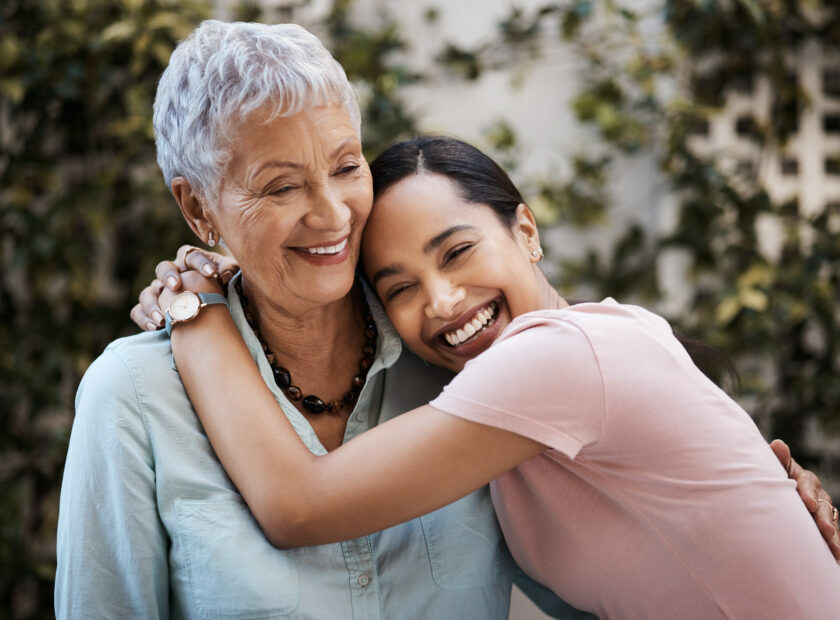 Happy, hug and portrait of a mother and woman in a garden on mothers day with love and gratitude. Smile, family and an adult daughter hugging a senior mom in a backyard or park for happiness