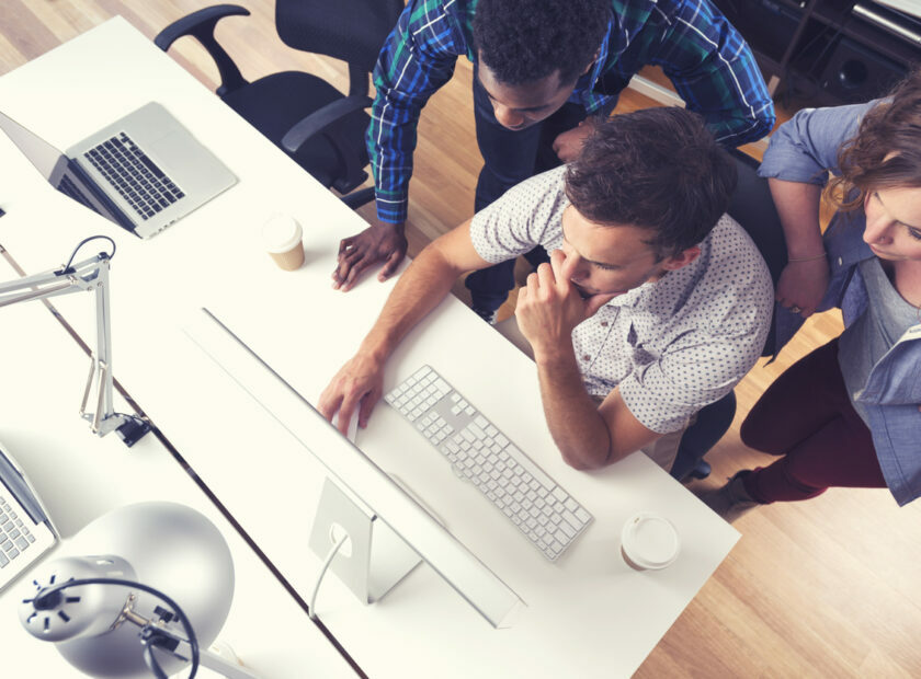 3 people working together in a small business office.