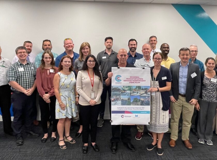 group of people holding program poster